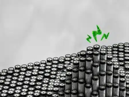 A bunch of black and white objects with a green arrow above them